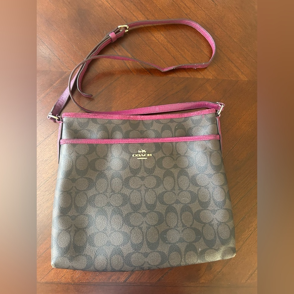 Coach Brown and Pink Trim Signature Crossbody It has a few minor flaws.